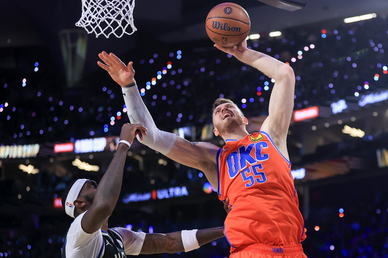 Oklahoma City Thunder center Isaiah Hartenstein (55) shoots against Milwaukee Bucks forward Bobby Portis (9) during the first half of the championship game in the NBA Cup basketball tournament Tuesday, Dec. 17, 2024, in Las Vegas. (AP Photo/Ian Maule)