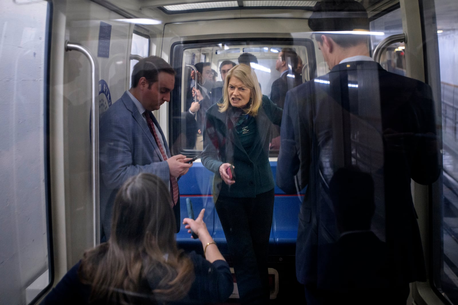 Sen. Lisa Murkowski, R-Alaska, right, talks with Sen. Katie Britt, R-Ala., left, as they ride the Senate subway at the Capitol, Thursday, Jan. 23, 2025, in Washington. (AP Photo/Rod Lamkey, Jr.)