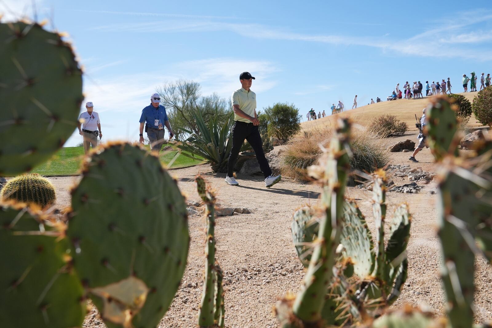 Jordan Spieth walks through the desert to get to the fourth green during the third round of the Phoenix Open golf tournament at TPC Scottsdale, Saturday, Feb. 8, 2025, in Scottsdale, Ariz. (AP Photo/Ross D. Franklin)