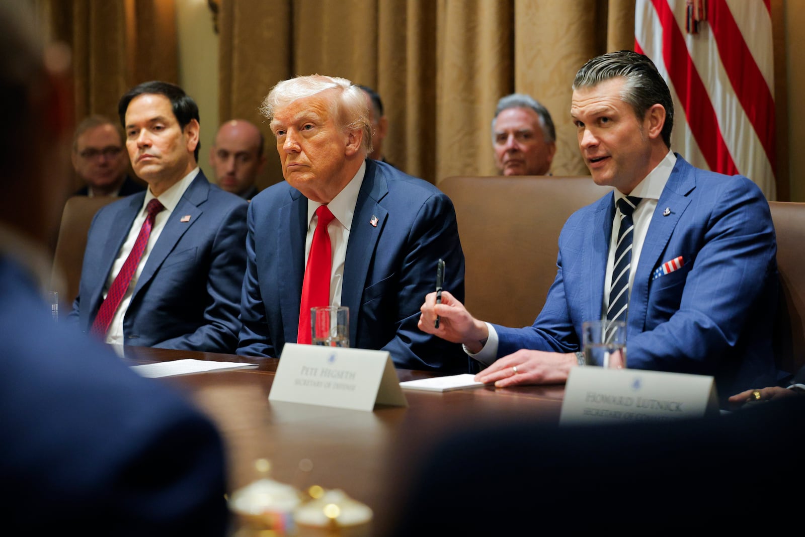 President Donald Trump listens during a Cabinet meeting at the White House in Washington, Tuesday, Feb. 26, 2025, as Secretary of State Marco Rubio and Defense Secretary Pete Hegseth listen. (Pool via AP)