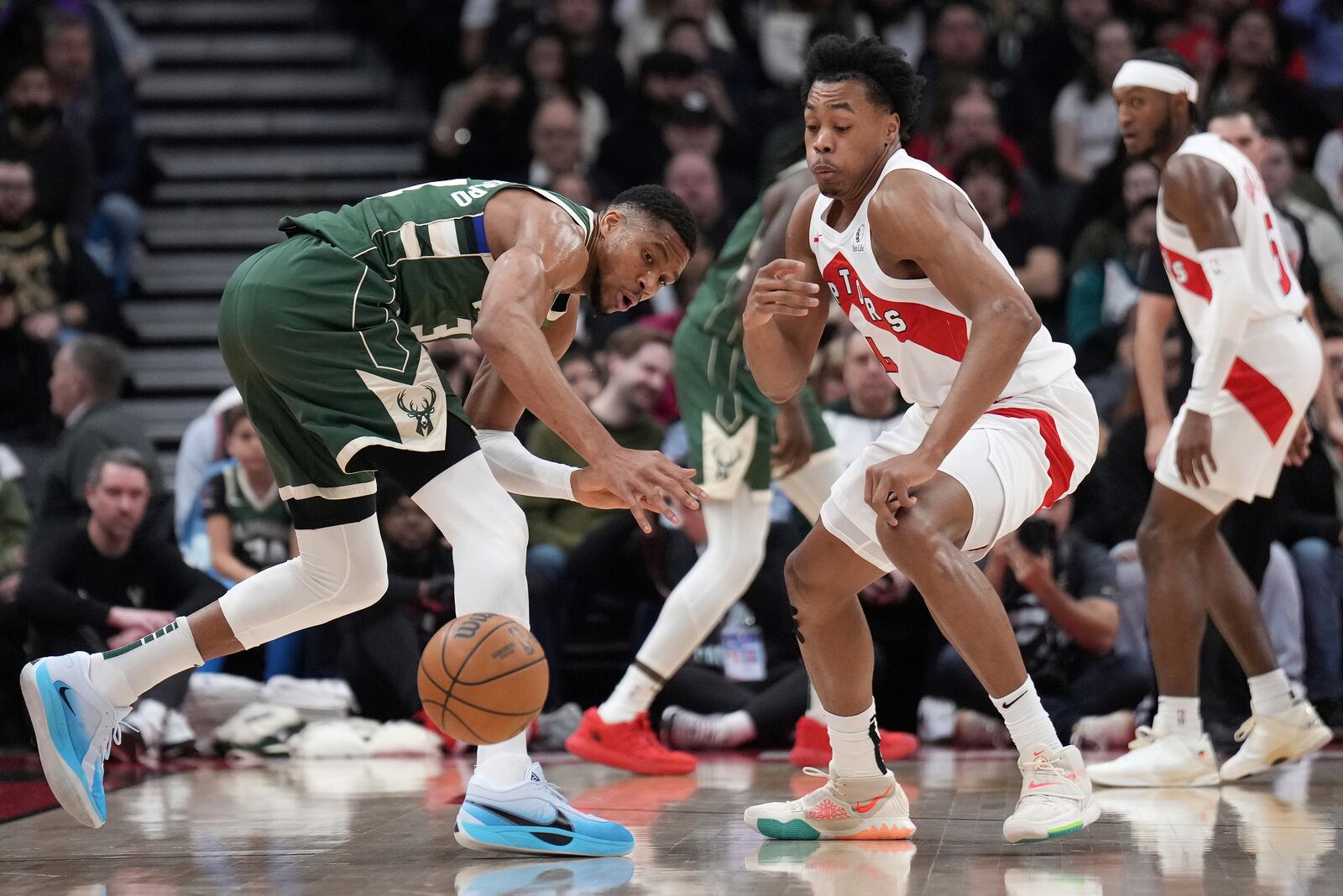 Toronto Raptors forward Scottie Barnes steals the ball from Milwaukee Bucks forward Giannis Antetokounmpo during the first half of an NBA basketball game in Toronto, Monday, Jan. 6, 2025. (Nathan Denette/The Canadian Press via AP)