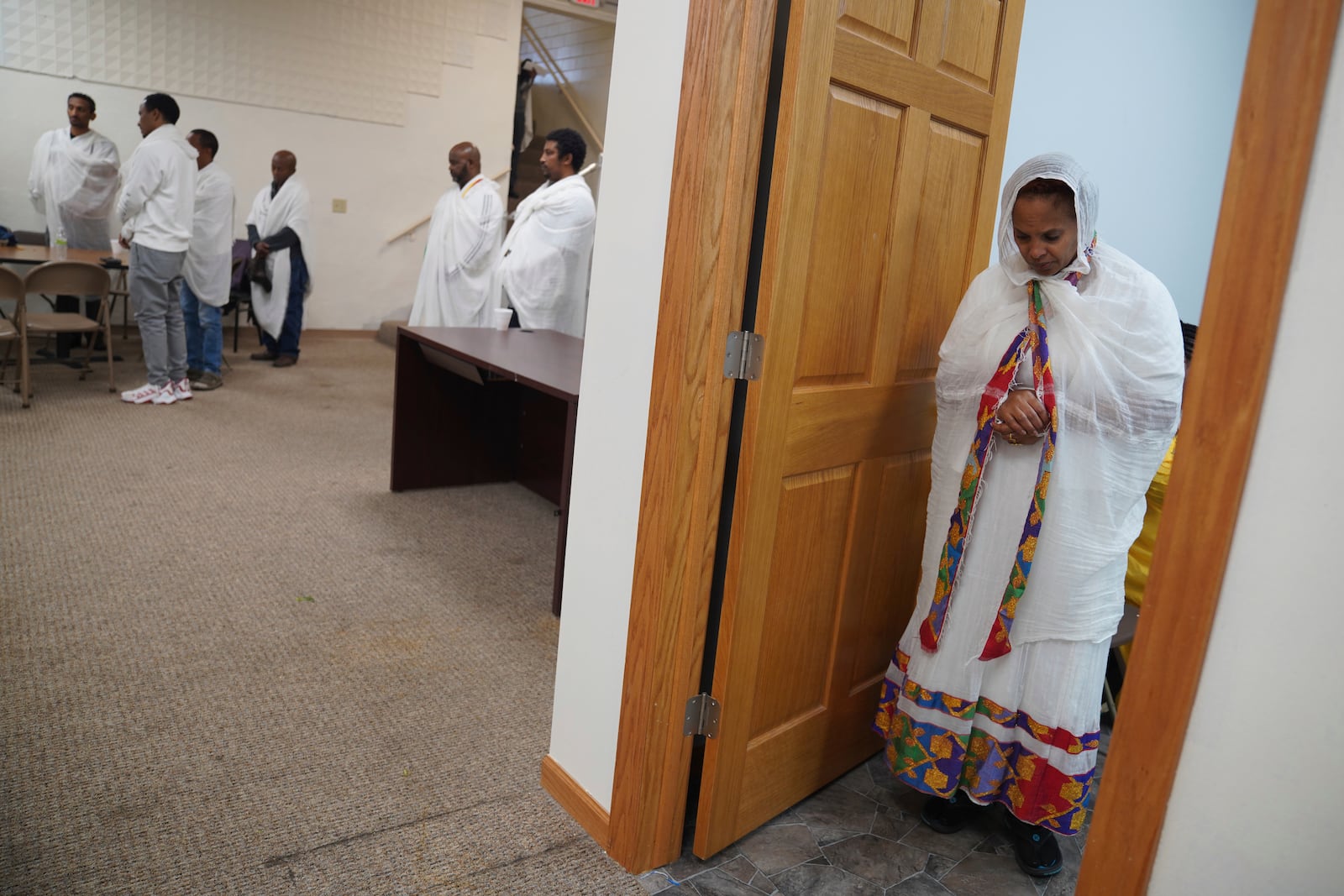 Members of the Ethiopian Orthodox Tewahedo Church pray after a post-liturgy lunch of pancake-like injera bread on Sunday, Oct. 20, 2024, in Worthington, Minn. (AP Photo/Jessie Wardarski)