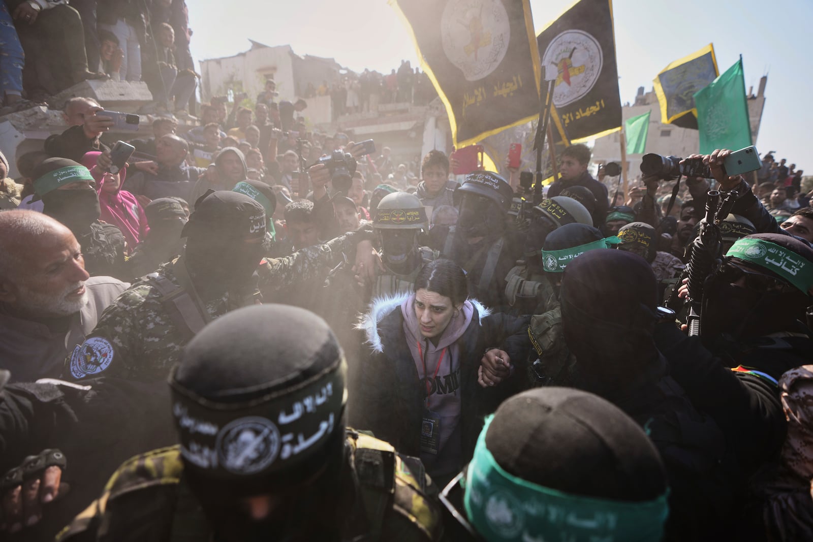 Israeli soldier Arbel Yehoud, 29, who has been held hostage by Hamas in Gaza since October 7, 2023, is escorted by Hamas and Islamic Jihad fighters as she is handed over to the Red Cross in Khan Younis, southern Gaza Strip, Thursday Jan. 30, 2025.(AP Photo/Abdel Kareem Hana)