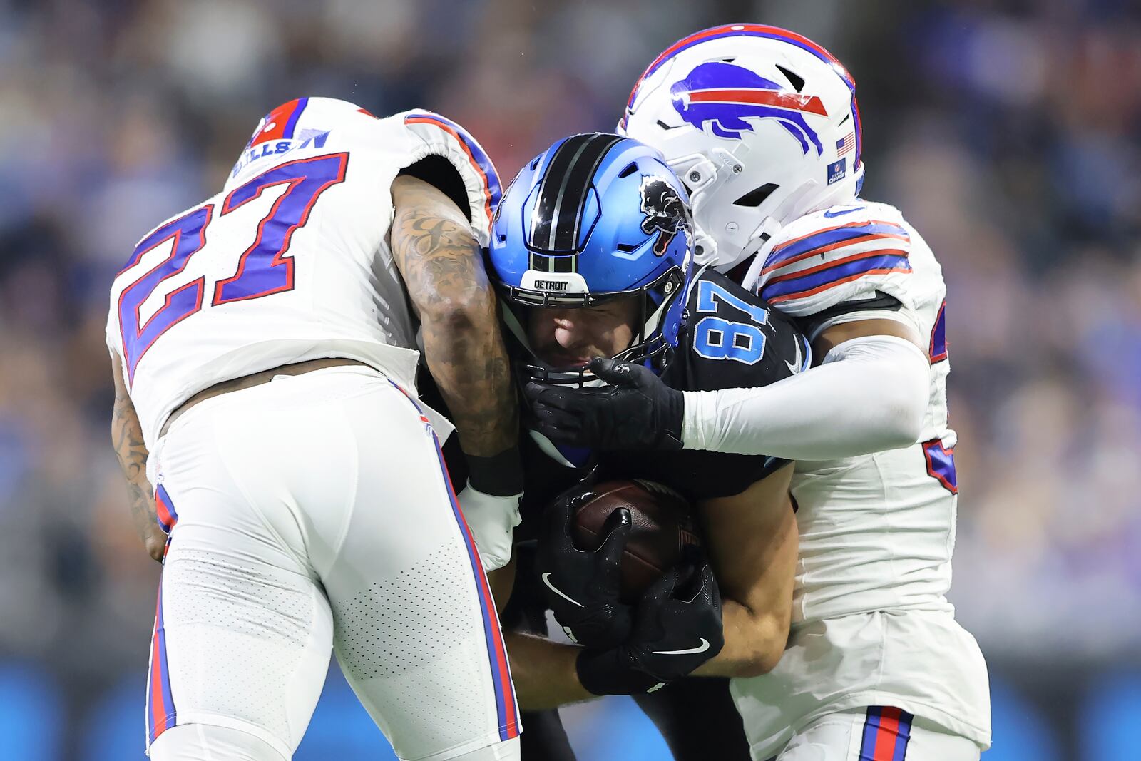 Detroit Lions tight end Sam LaPorta, middle, is tackled by Buffalo Bills safety Kareem Jackson (27) and cornerback Cam Lewis during the second half of an NFL football game, Sunday, Dec. 15, 2024, in Detroit. (AP Photo/Rey Del Rio)