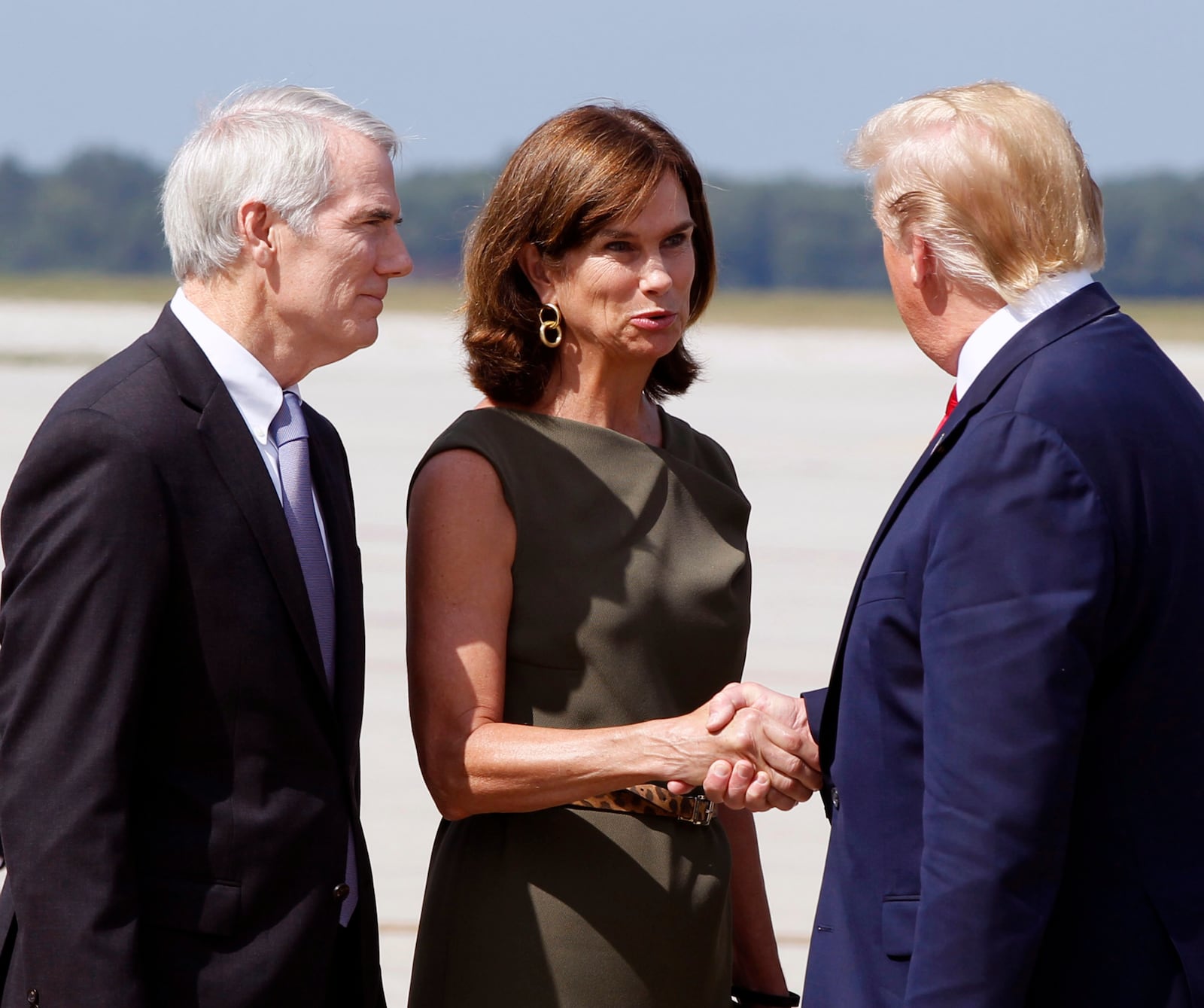 U.S. Senator Rob Portman (R) and his wife Jane are greeted by President Trump at Wright-Patterson Air Force Base, Wednesday, Aug. 7, 2019, in Dayton, Ohio. Trump was in Dayton to visit with families of victims of the mass shooting that took place in the Oregon District.(Ty Greenlees/Dayton Daily News/pool)