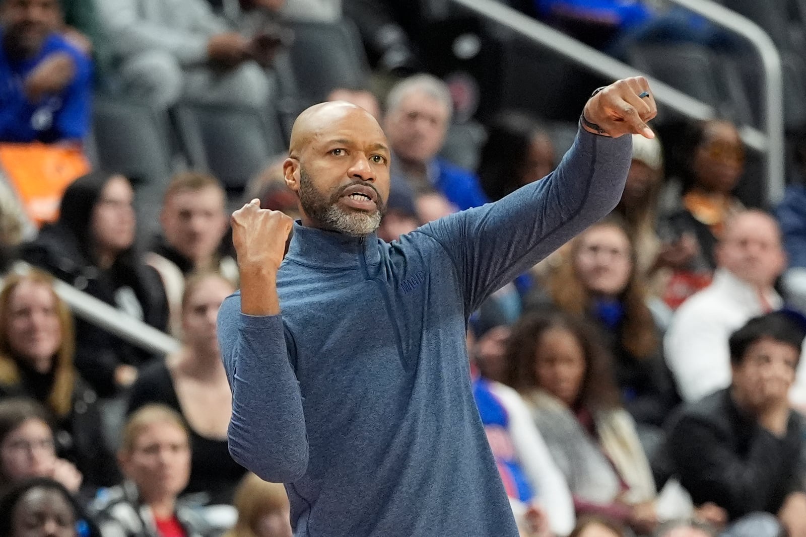 Orlando Magic head coach Jamahl Mosley signals during the first half of an NBA basketball game against the Detroit Pistons, Wednesday, Jan. 1, 2025, in Detroit. (AP Photo/Carlos Osorio)