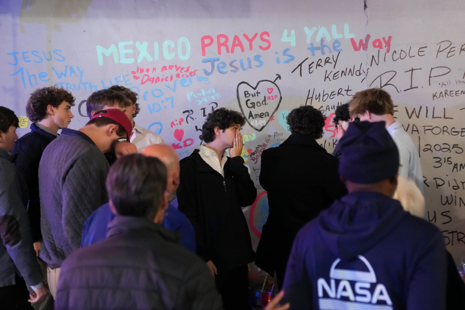 Friends of Kareem Badawi, a victim of the deadly truck attack on New Year's Day in New Orleans, pray at a memorial for victims after attending his funeral, Friday, Jan. 3, 2025. (AP Photo/Gerald Herbert)