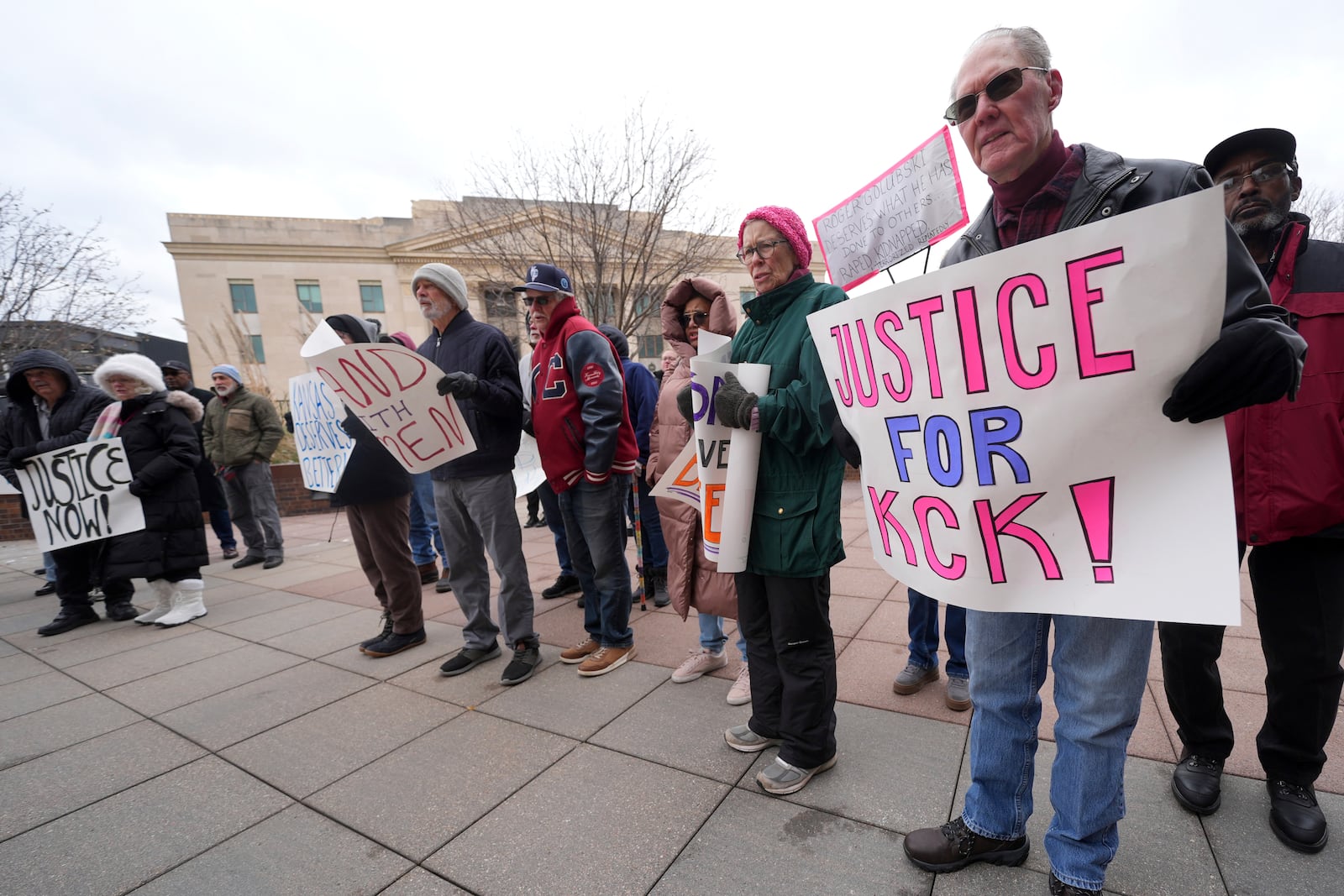 People rally outside the federal courthouse on what was to be the opening day of a trial for former police detective Roger Golubski, Monday, Dec. 2, 2024, in Topeka, Kan. (AP Photo/Charlie Riedel)