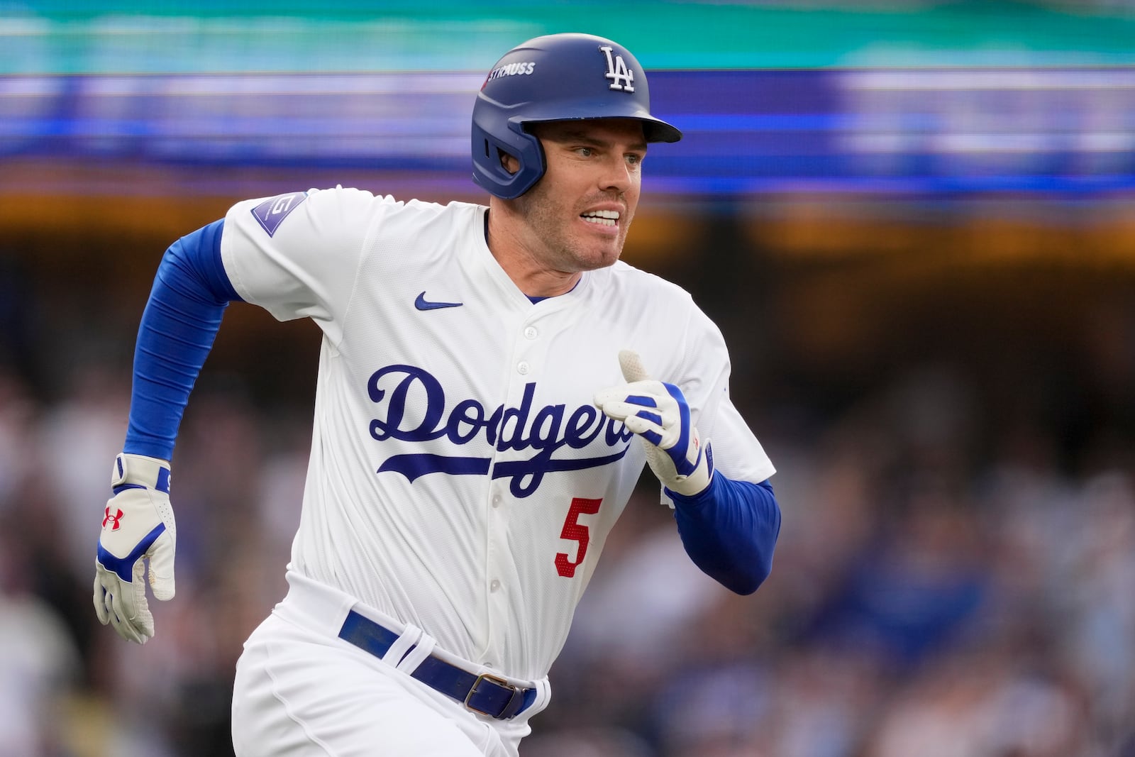 Los Angeles Dodgers' Freddie Freeman runs to first base as he singles during the first inning in Game 5 of a baseball NL Division Series against the San Diego Padres, Friday, Oct. 11, 2024, in Los Angeles. (AP Photo/Mark J. Terrill)