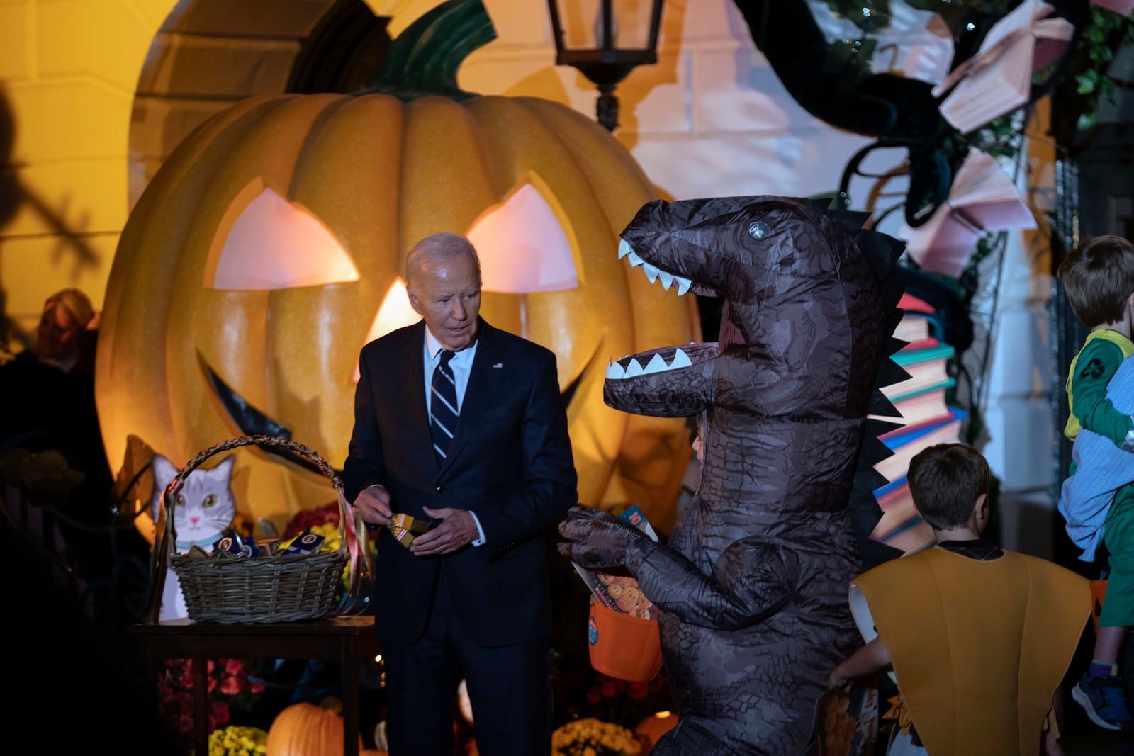 President Joe Biden gives treats to trick-or-treaters at the South Lawn of the White House on Halloween in Washington, Wednesday, Oct. 30, 2024. (AP Photo/Jose Luis Magana)