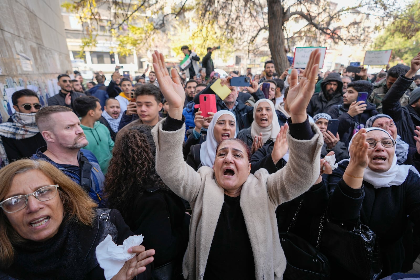 Mourners, including his sister Amal, left, attend the funeral of Syrian activist Mazen al-Hamada in Damascus Thursday Dec. 12, 2024. Al-Hamad's mangled corpse was found wrapped in a bloody sheet in Saydnaya prison. He had fled to Europe but returned to Syria in 2020 and was imprisoned upon arrival. (AP Photo/Hussein Malla)