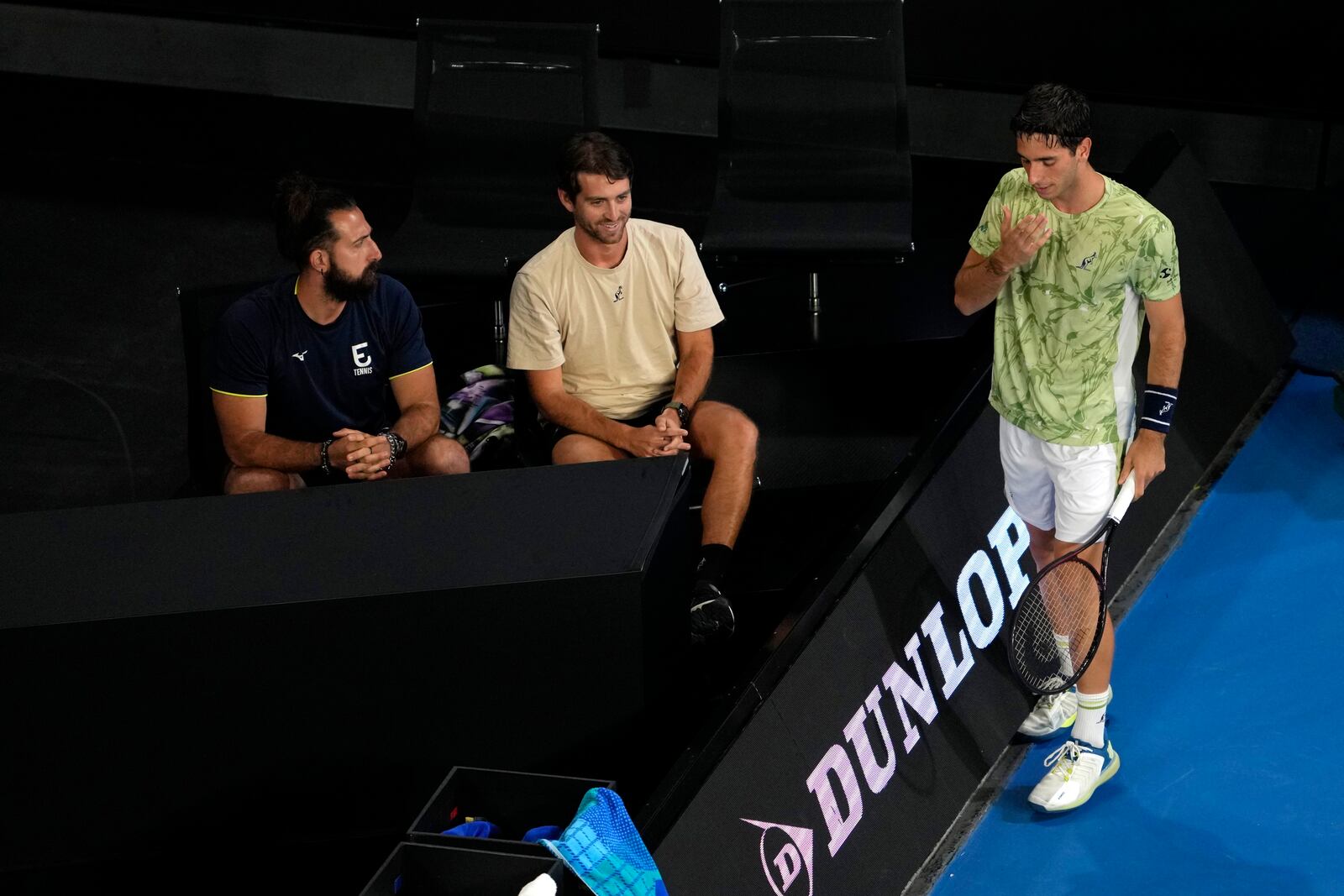 Matteo Gigante, right, of Italy stands by his coaches during his first round match against Ugo Humbert of France during their first round match at the Australian Open tennis championship in Melbourne, Australia, Sunday, Jan. 12, 2025. (AP Photo/Ng Han Guan)