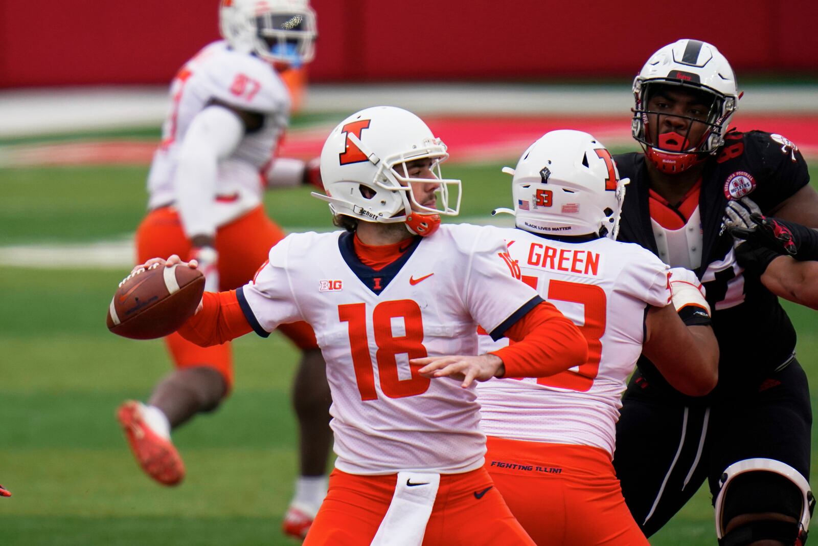 Illinois quarterback Brandon Peters (18) throws behind the block from offensive lineman Kendrick Green (53) during the first half of an NCAA college football game against Nebraska in Lincoln, Neb., Saturday, Nov. 21, 2020. (AP Photo/Nati Harnik)