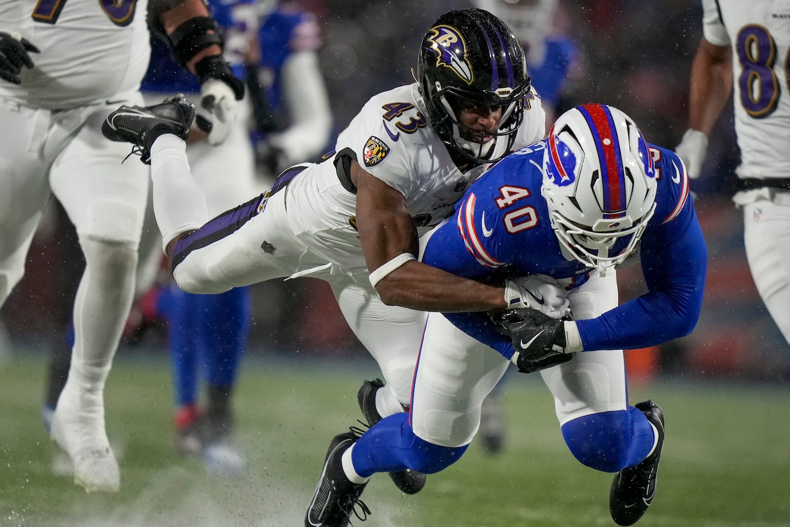 Baltimore Ravens running back Justice Hill (43) tackles Buffalo Bills linebacker Von Miller (40) after Miller recovered a fumble during the second quarter of an NFL divisional playoff football game, Sunday, Jan. 19, 2025, in Orchard Park, N.Y. (AP Photo/Frank Franklin II)