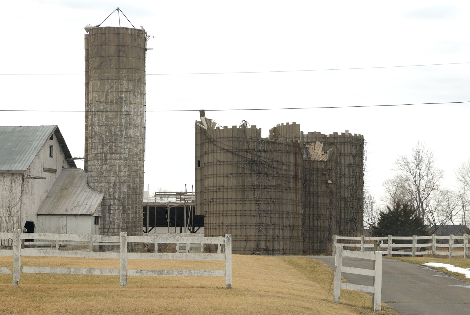 The iconic grain silos along South Charleston Pike are still damaged a year after the tornado. BILL LACKEY/STAFF