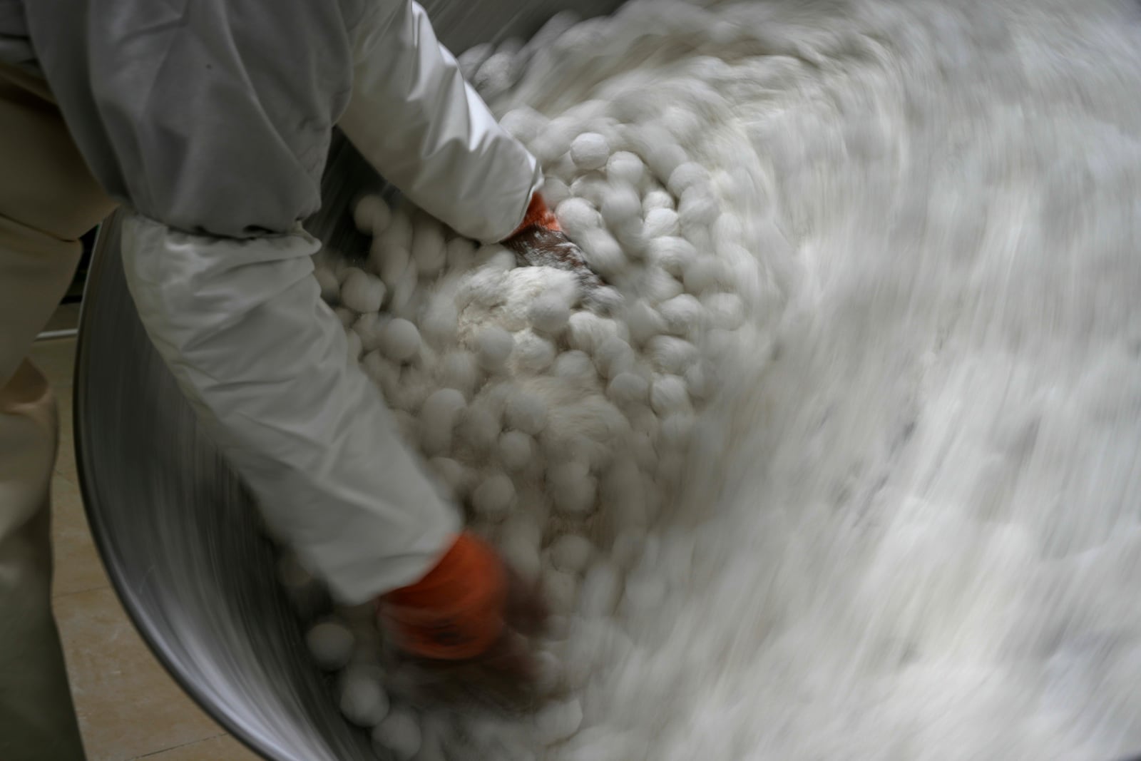 A worker at the Jinfang Snacks Shop makes yuanxiao, a traditional Chinese food made with glutinous rice flour and sweet fillings consumed as part of the upcoming Lantern Festival celebrations in Beijing, Tuesday, Feb. 11, 2025. (AP Photo/Ng Han Guan)