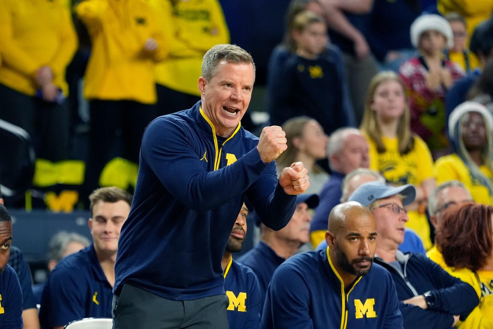 Michigan head coach Dusty May signals from the sideline during the second half of an NCAA college basketball game against Purdue Fort Wayne, Sunday, Dec. 22, 2024, in Ann Arbor, Mich. (AP Photo/Carlos Osorio)