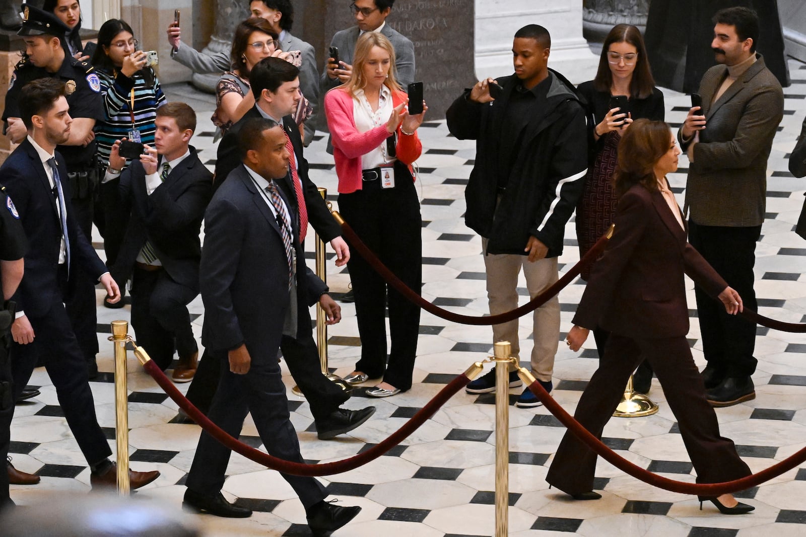 Vice President Kamala Harris, right, walks through Statuary Hall to the House Chamber before a joint session of Congress convenes to confirm the Electoral College votes, affirming President-elect Donald Trump’s victory in the presidential election, Monday, Jan. 6, 2025, at the U.S. Capitol in Washington. (AP Photo/John McDonnell)