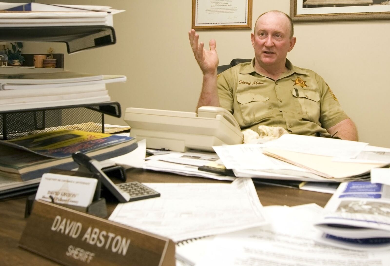 Pickens County Sheriff David Abston speaks with reporters in July 2006 about a jailbreak from the county jail, located in Carrollton, Ala. Abston, 68, was arrested Friday, June 14, 2019, and has agreed to plead guilty to federal charges of wire fraud and filing a false tax return. The longtime sheriff, who has resigned, is accused of scamming a food bank and his own church to pocket $400,000 under a law that let state sheriffs keep excess cash from jail feeding funds.