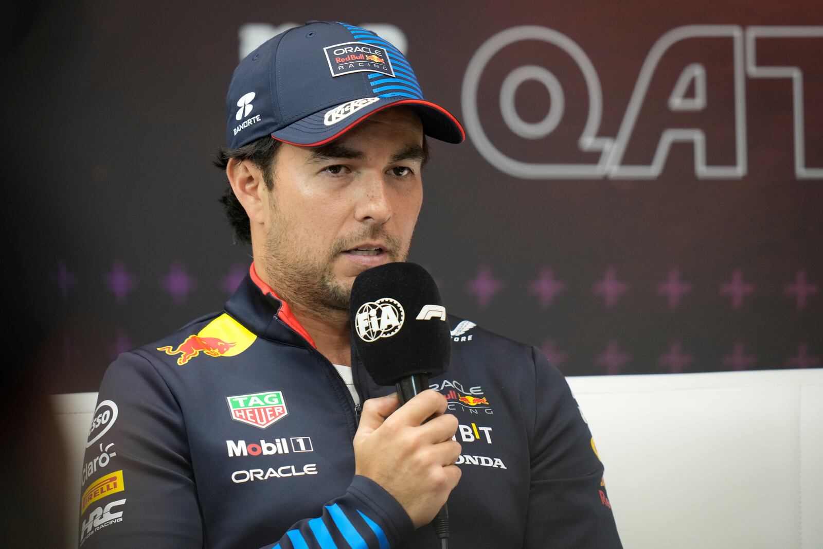 Red Bull driver Sergio Perez of Mexico attends a news conference at the Lusail International Circuit in Lusail, Qatar, ahead of the Qatar Grand Prix, Thursday, Nov. 28, 2024. (AP Photo/Darko Bandic)