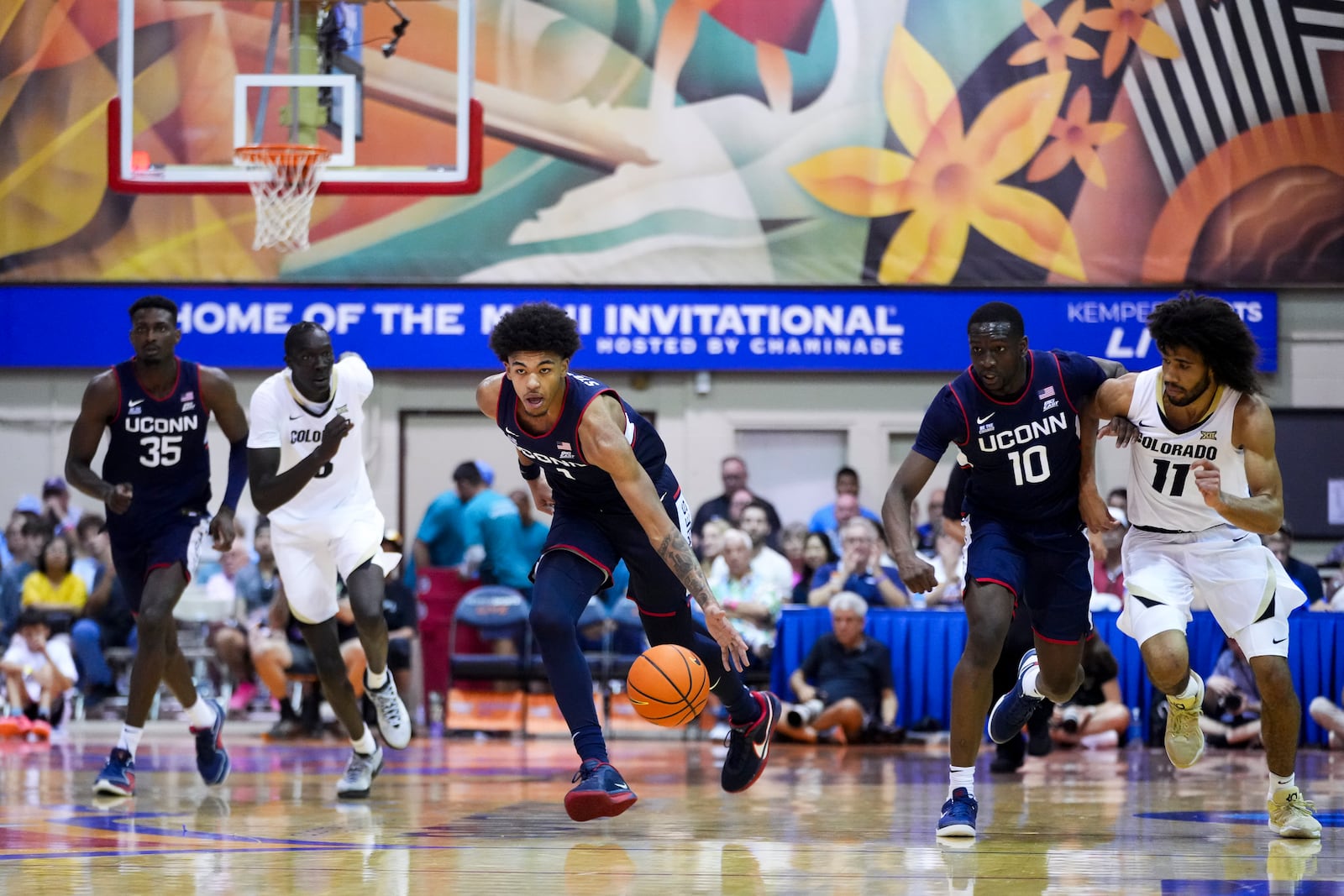 UConn forward Jaylin Stewart, center, grabs the loose ball against Colorado during the second half of an NCAA college basketball game at the Maui Invitational Tuesday, Nov. 26, 2024, in Lahaina, Hawaii. Colorado won 73-72. (AP Photo/Lindsey Wasson)