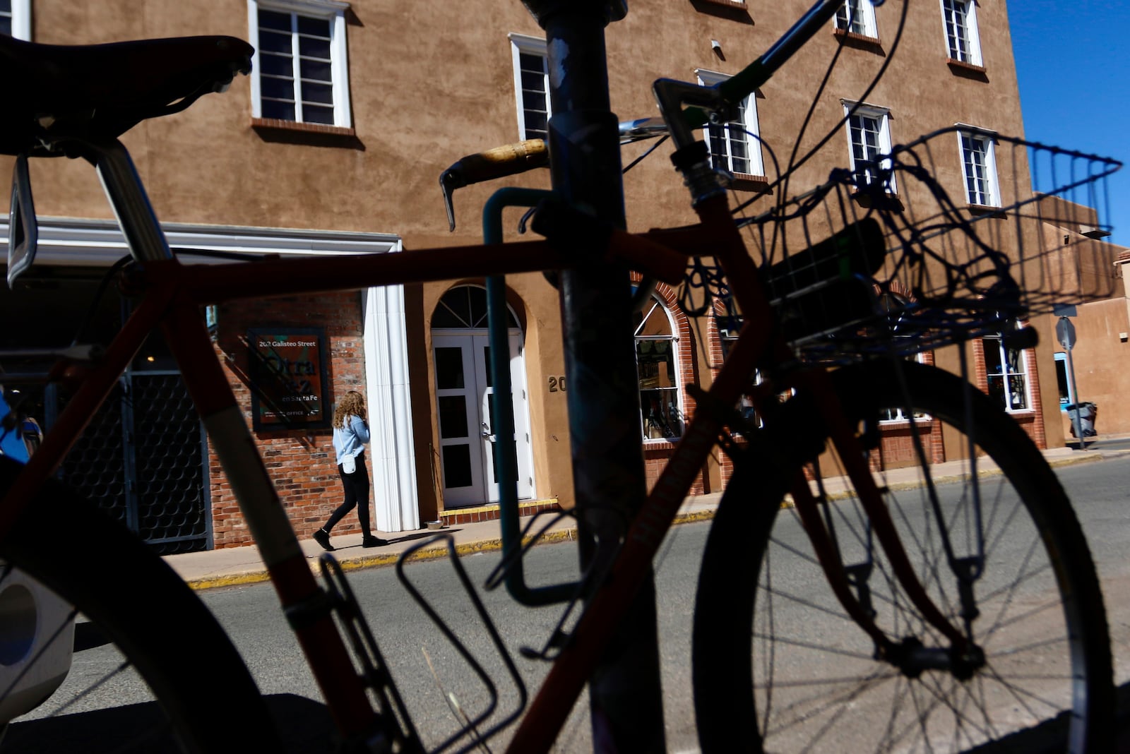 People walk around the Santa Fe Plaza in Santa Fe, New Mexico, Friday, Feb. 28, 2025. (AP Photo/Ty O'Neil)