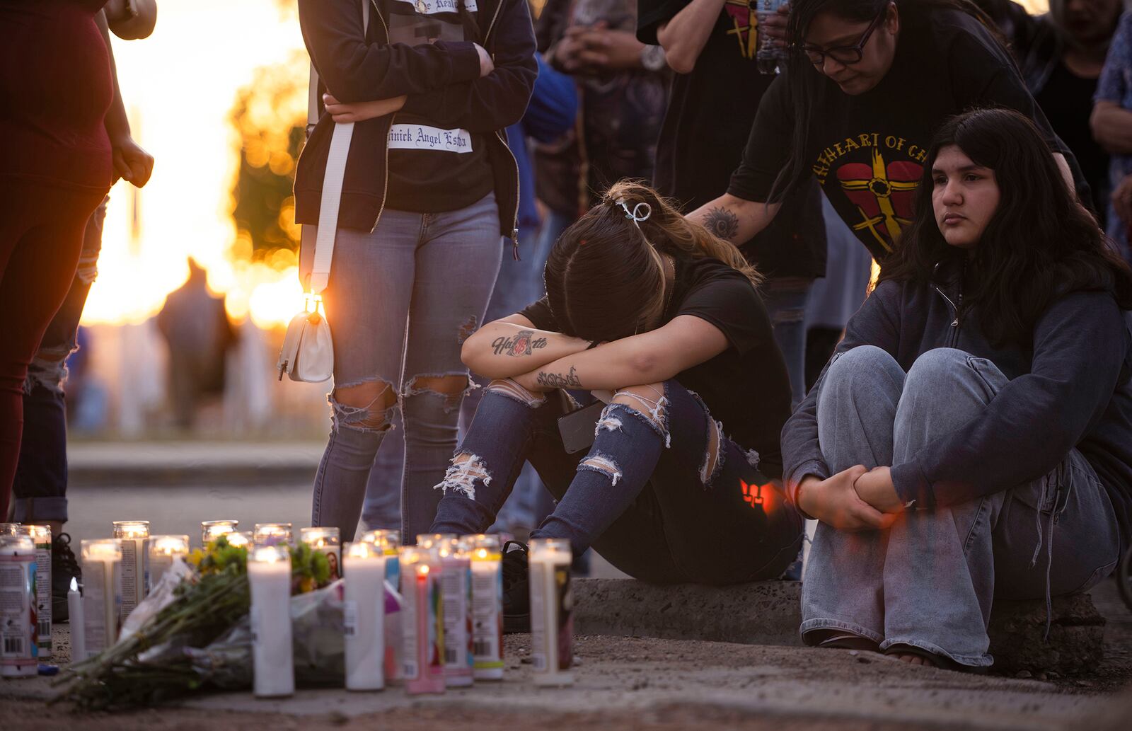 Family and friends mourn shooting victims during a vigil Young Park in Las Cruces, N.M., on Sunday, March 23, 2025. (Chancey Bush/The Albuquerque Journal via AP)