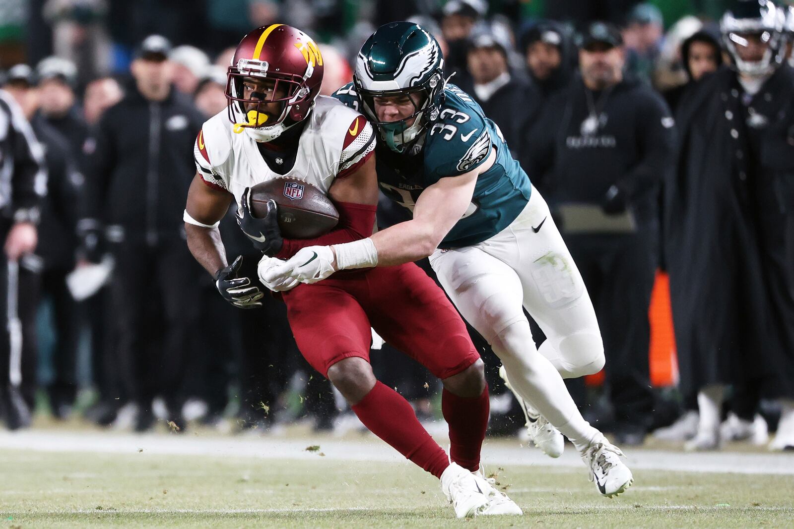 FILE - Philadelphia Eagles cornerback Cooper DeJean (33) takes down Washington Commanders wide receiver Jamison Crowder (80) during the NFC Championship NFL football game, Sunday, Jan. 26, 2025, in Philadelphia. (AP Photo/Daniel Kucin Jr., File)