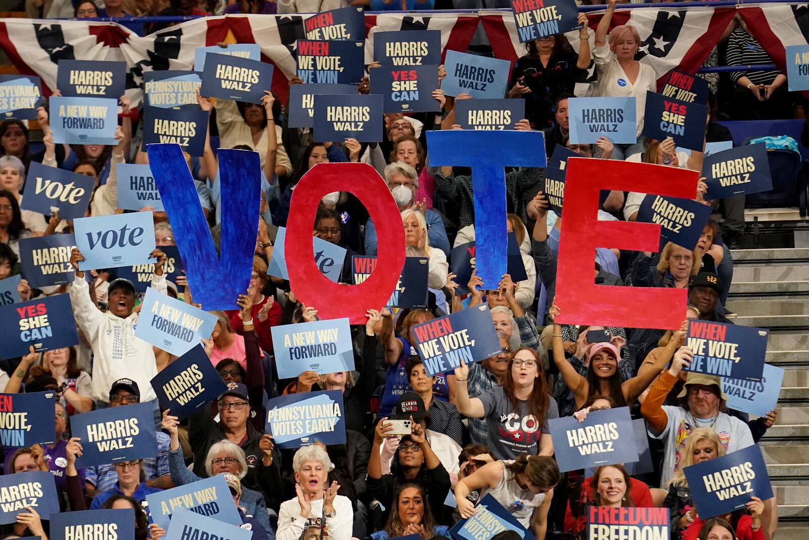 Attendees hold signs as former President Barack Obama speaks during a campaign rally supporting Democratic presidential nominee Vice President Kamala Harris, Thursday, Oct. 10, 2024, at the University of Pittsburgh's Fitzgerald Field House in Pittsburgh. (AP Photo/Matt Freed)