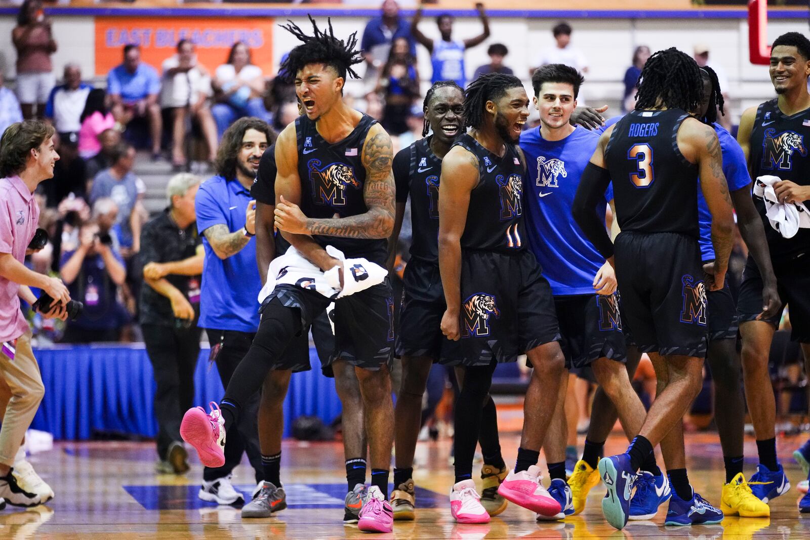 Memphis guard PJ Haggerty, left, reacts to beating UConn 99-97 in overtime in an NCAA college basketball game at the Maui Invitational Monday, Nov. 25, 2024, in Lahaina, Hawaii. (AP Photo/Lindsey Wasson)