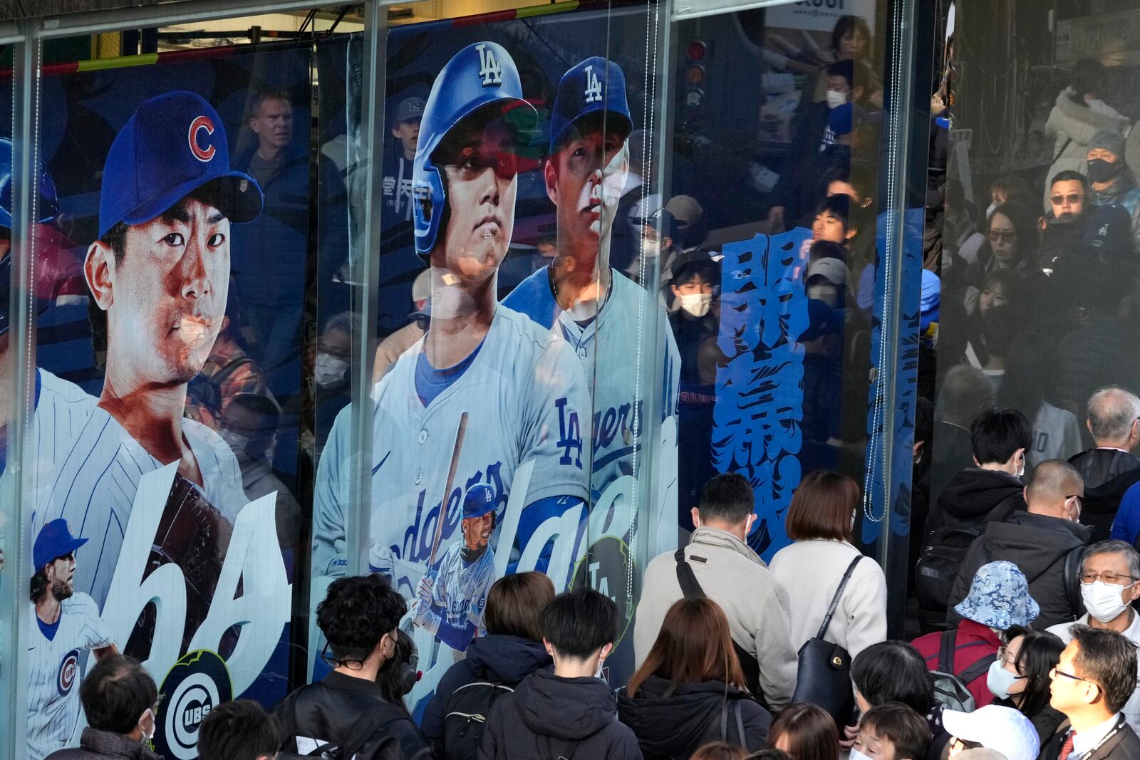 People wait in queue to enter a MLB official shop before an MLB Japan Series baseball game between the Los Angeles Dodgers and the Chicago Cubs at Tokyo Dome, in Tokyo, Tuesday, March 18, 2025. (AP Photo/Shuji Kajiyama)