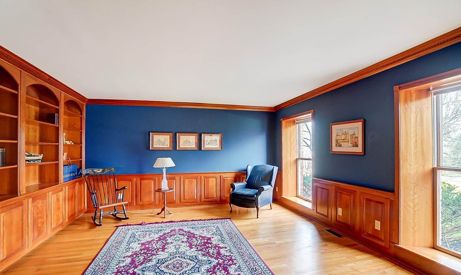 The living room has hardwood floors and built in bookcases.