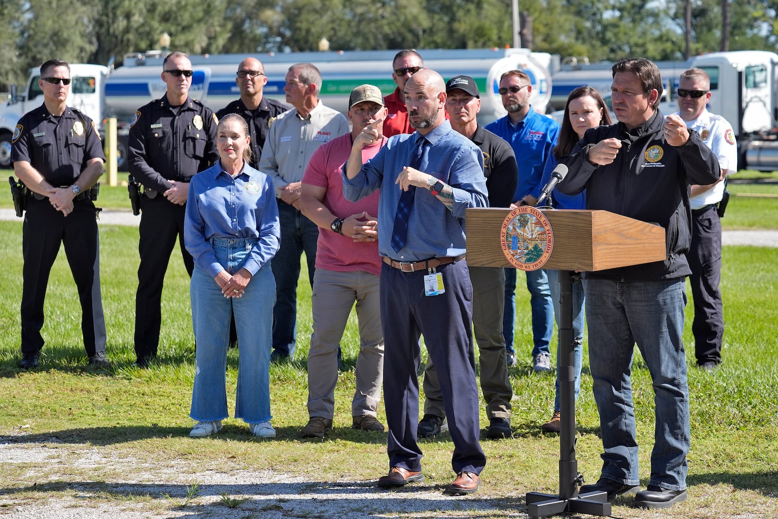 Florida Gov. Ron DeSantis, second from right, gestures as he holds a news conference after Hurricane Milton at a fuel depot Saturday, Oct. 12, 2024, in Plant City, Fla. (AP Photo/Chris O'Meara)