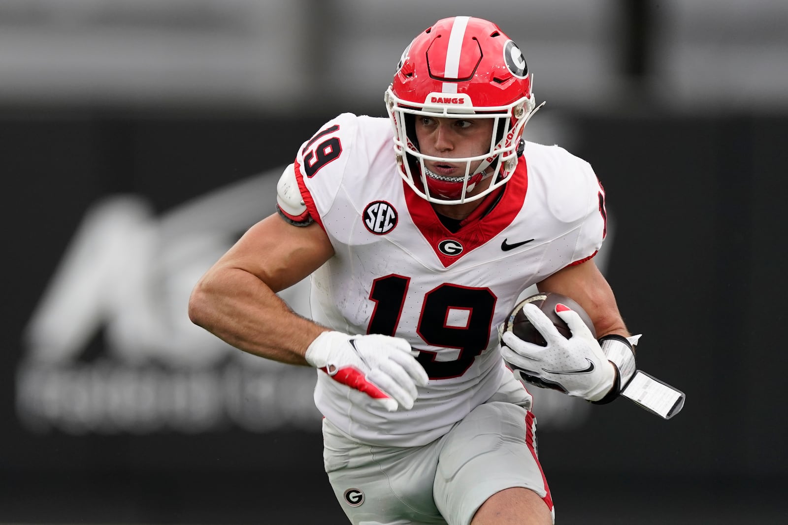 FILE -Georgia tight end Brock Bowers (19) runs the ball after a catch against Vanderbilt in the first half of an NCAA college football game Saturday, Oct. 14, 2023, in Nashville, Tenn. Junior tight end Brock Bowers, who led No. 6 Georgia in receiving despite missing four games, confirmed his plans to enter the NFL draft on Tuesday night, Jan. 2, 2024. (AP Photo/George Walker IV, File)