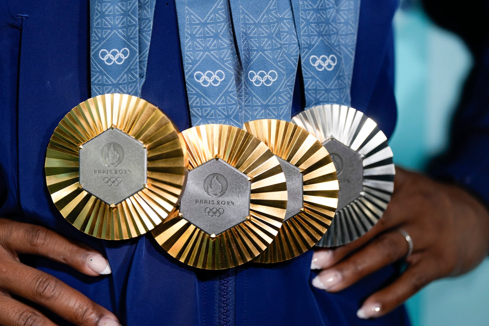 FILE - Simone Biles, of the United States, poses with her medals after the women's artistic gymnastics individual apparatus finals Bercy Arena at the 2024 Summer Olympics, Monday, Aug. 5, 2024, in Paris, France. (AP Photo/Charlie Riedel, File)