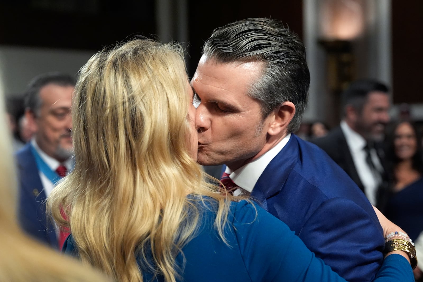 Pete Hegseth, President-elect Donald Trump's choice to be Defense secretary, kisses his wife Jennifer Rauchet after his Senate Armed Services Committee for his confirmation hearing, at the Capitol in Washington, Tuesday, Jan. 14, 2025. (AP Photo/Alex Brandon)