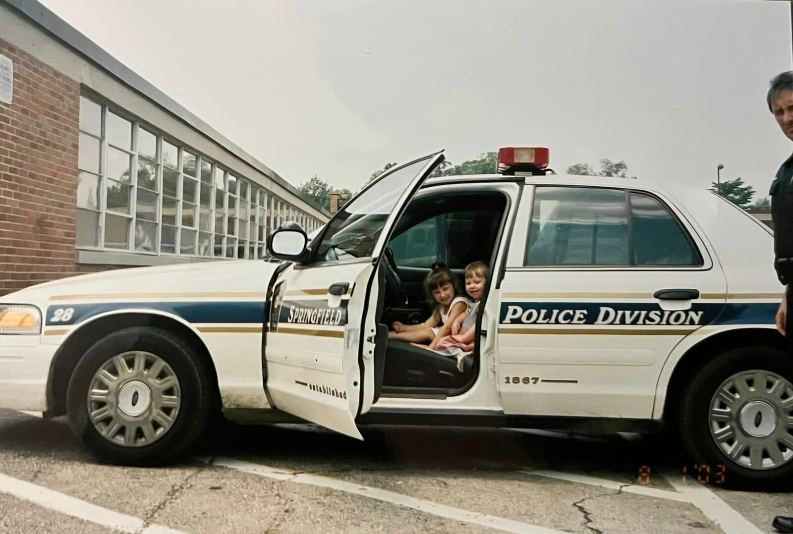 Sisters Annmeri (front) and Antonia Turner are shown 20 years ago in a Springfield Police Division cruiser. The sisters have followed in the footsteps of their father, retired Lt. Lou Turner. CONTRIBUTED