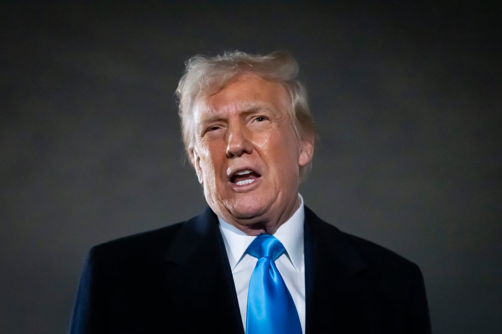 President Donald Trump speaks to reporters next to Air Force One after arriving back at Joint Base Andrews, Md., Sunday, Feb. 2, 2025. (AP Photo/Ben Curtis)