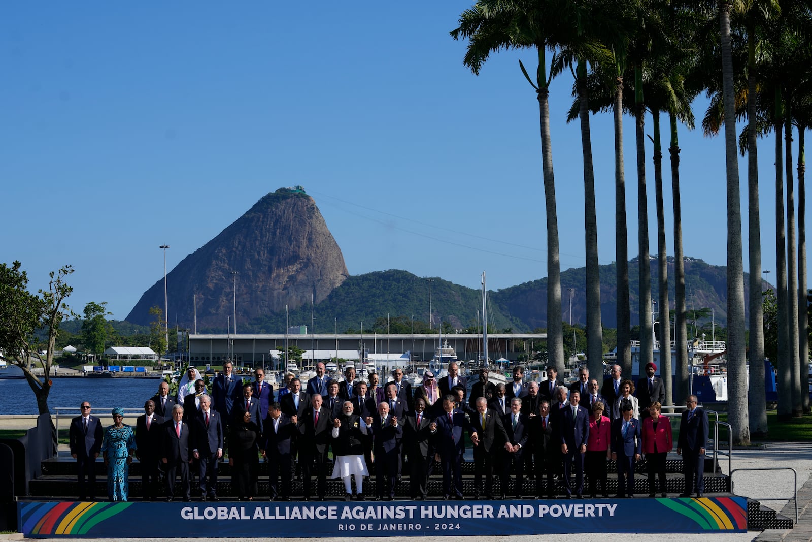 Backdropped by Sugar Loaf mountain, leaders attending the G20 Summit pose for a group photo in Rio de Janeiro, Monday, Nov. 18, 2024. (AP Photo/Eraldo Peres)