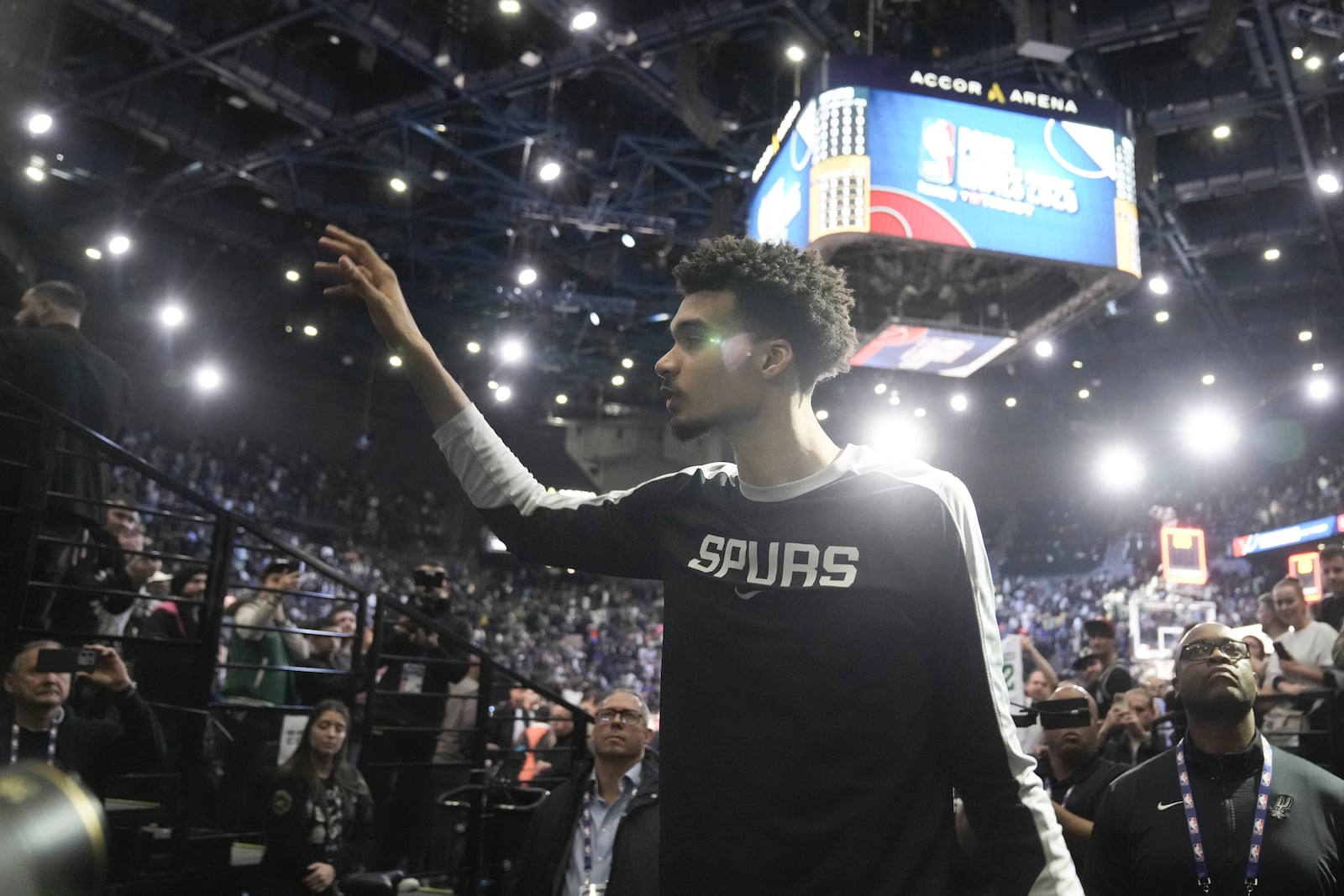 San Antonio Spurs center Victor Wembanyama (1) waves to fans as he leaves the court following a Paris Games 2025 NBA basketball game against the Indiana Pacers in Paris, Saturday, Jan. 25, 2025. (AP Photo/Thibault Camus)