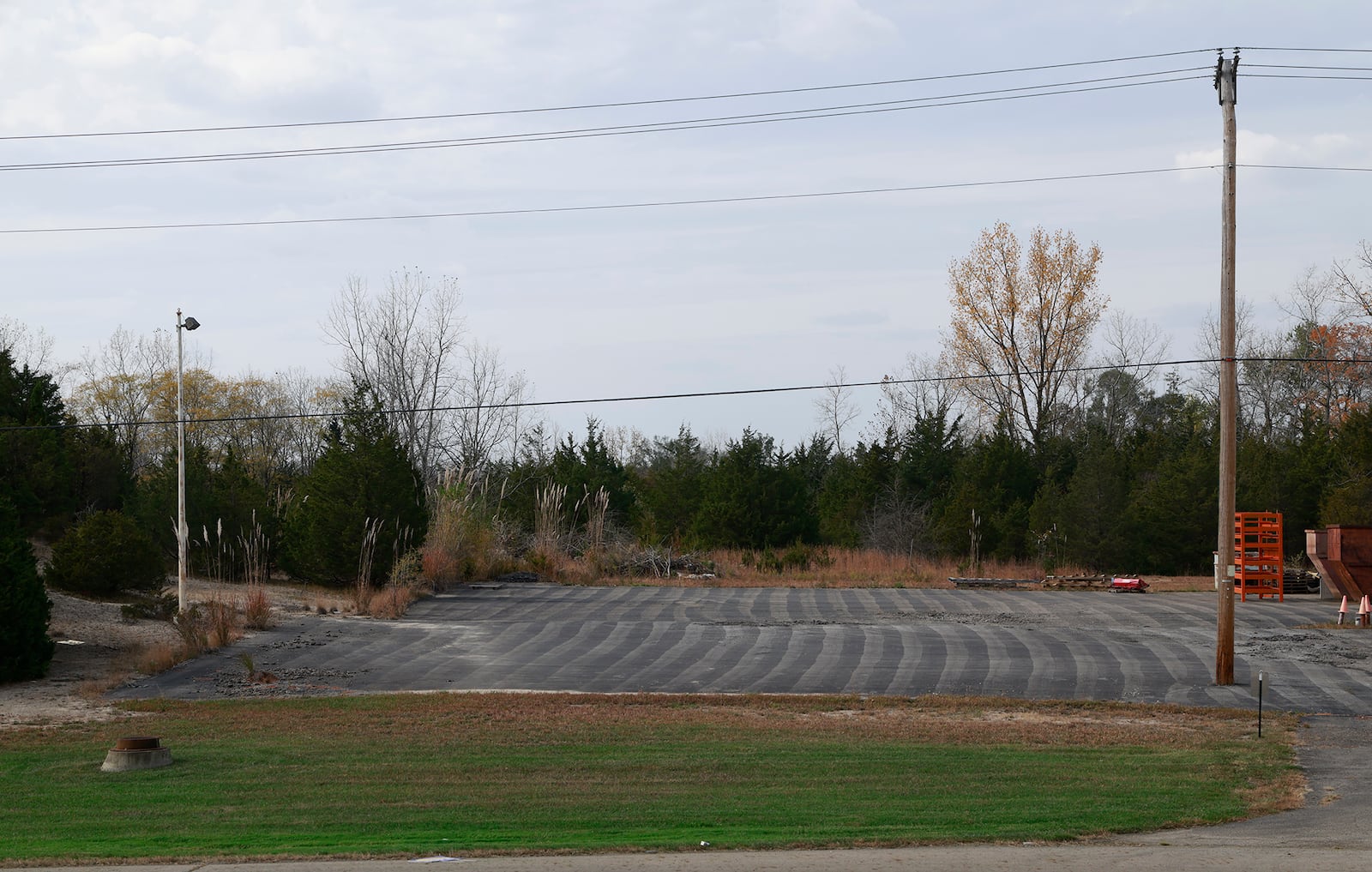 The decades-old New Carlisle Landfill sits behind this parking lot on the west side of Ohio 235, just south of the city. BILL LACKEY/STAFF