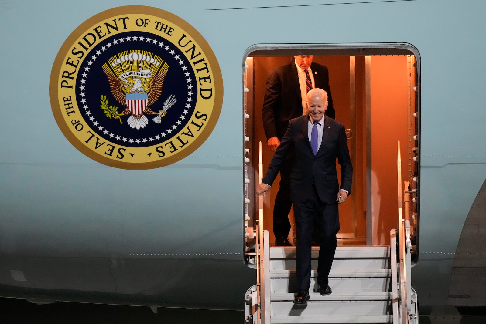 President Joe Biden walks down the stairs of Air Force One as he arrives at Brandenburg Airport in Schoenefeld near Berlin, Germany, Thursday, Oct. 17, 2024. (AP Photo/Matthias Schrader)