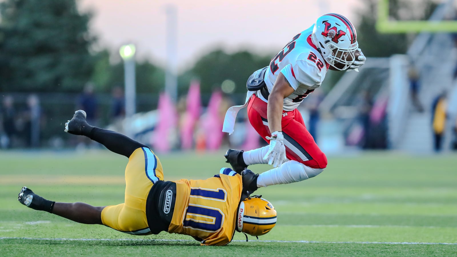 Springfield High School senior Kyron Dolby tackles Wayne junior Isaiah Thompson during their game against Springfield on Friday night in Springfield. The Warriors won 36-6. CONTRIBUTED PHOTO BY MICHAEL COOPER