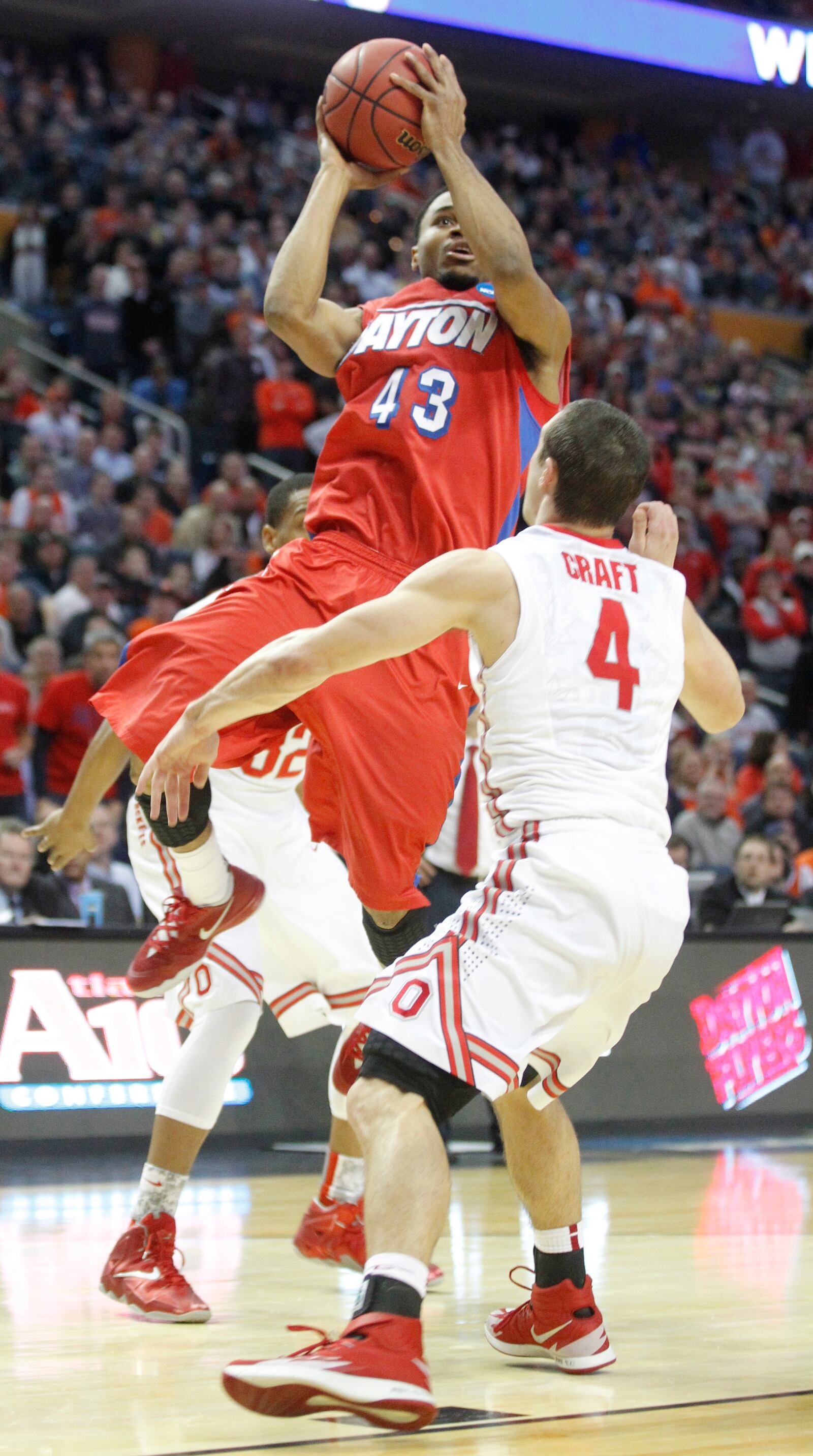 Dayton's Vee Sanford hits the game-winning shot with 3.8 seconds left over Ohio State's Aaron Craft in the second round of the NCAA tournament on Thursday, March 20, 2014, at the First Niagara Center in Buffalo, N.Y. David Jablonski/Staff