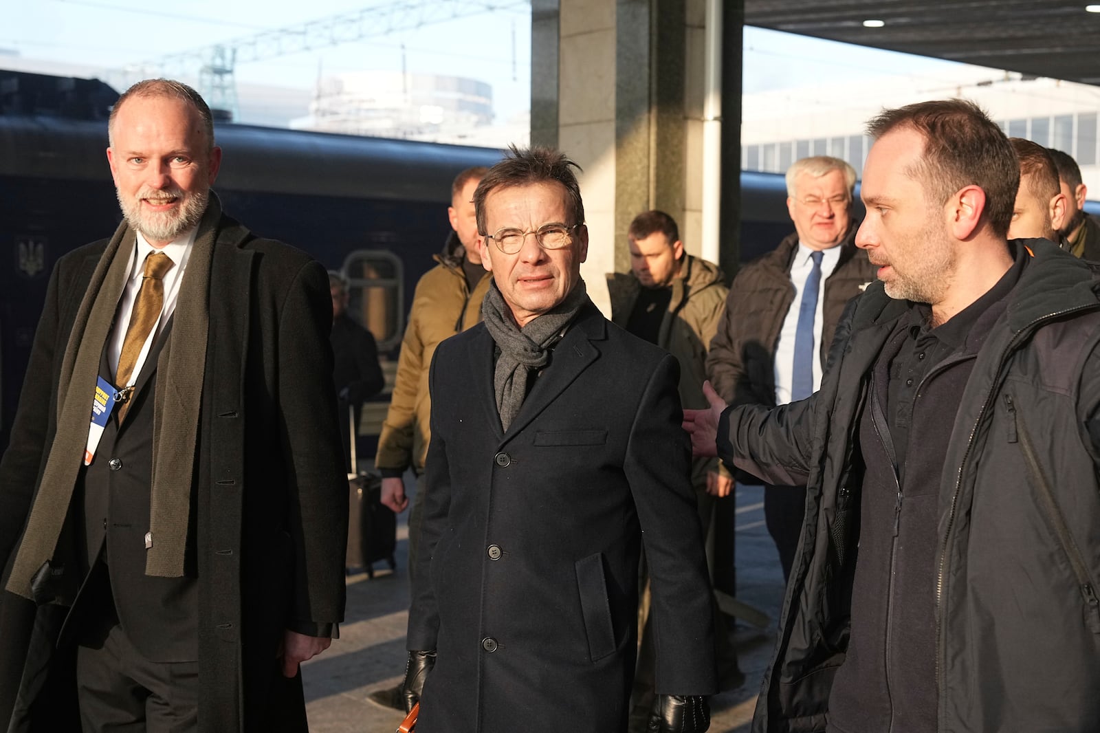 Sweden's Prime Minister Ulf Kristersson, center, arrives at a train station on the third anniversary of the Russian invasion of Ukraine, Kyiv, Ukraine, Monday, Feb. 24, 2025. (AP Photo/Efrem Lukatsky)