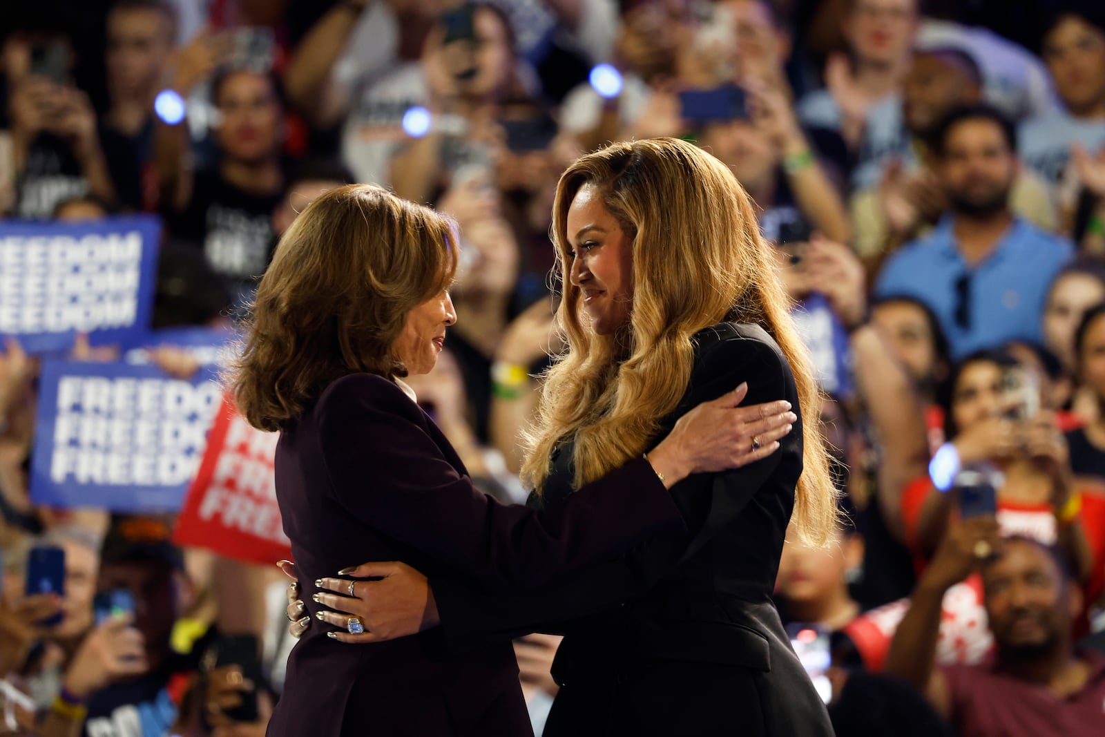 Musical artist Beyonce, right, and Democratic presidential nominee Vice President Kamala Harris, left, embrace on stage during a campaign rally Friday, Oct. 25, 2024, in Houston. (AP Photo/Annie Mulligan)