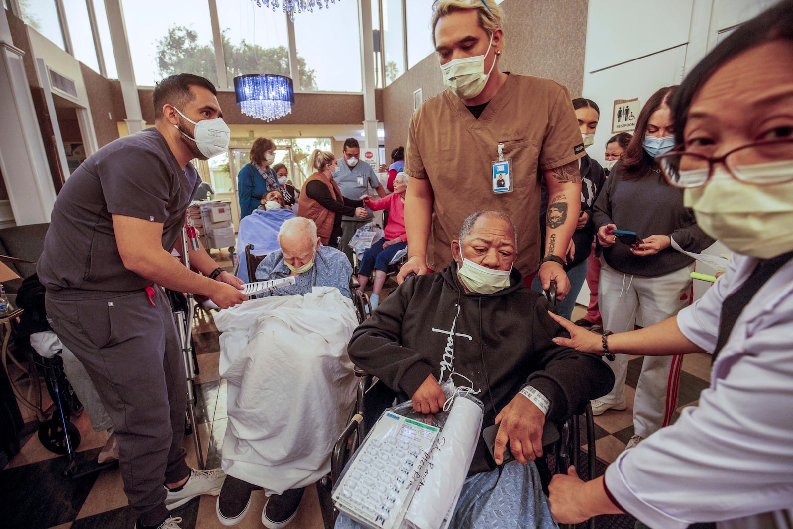 Residents are evacuated from a senior living facility as the Eaton Fire approaches Wednesday, Jan. 8, 2025, in Altadena, Calif. (AP Photo/Ethan Swope)