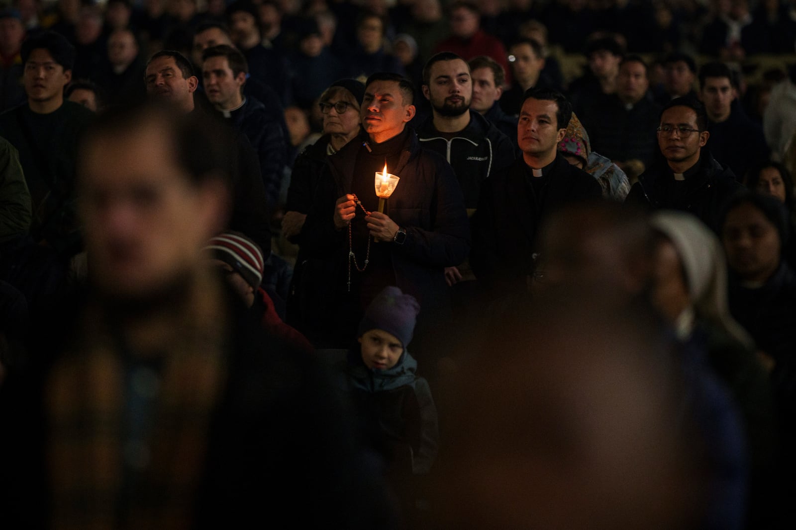 Catholic worshippers gather during a prayer of the Rosary for Pope Francis in St. Peter's Square at The Vatican, Monday, Feb. 24, 2025. (AP Photo/Bernat Armangue)