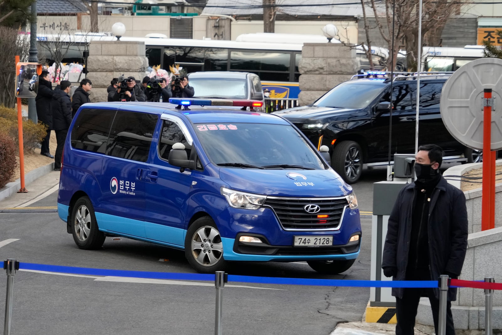 A blue van carrying impeached South Korean President Yoon Suk Yeol arrives at the Constitutional Court in Seoul, South Korea, Tuesday, Feb. 25, 2025. (AP Photo/Ahn Young-joon)