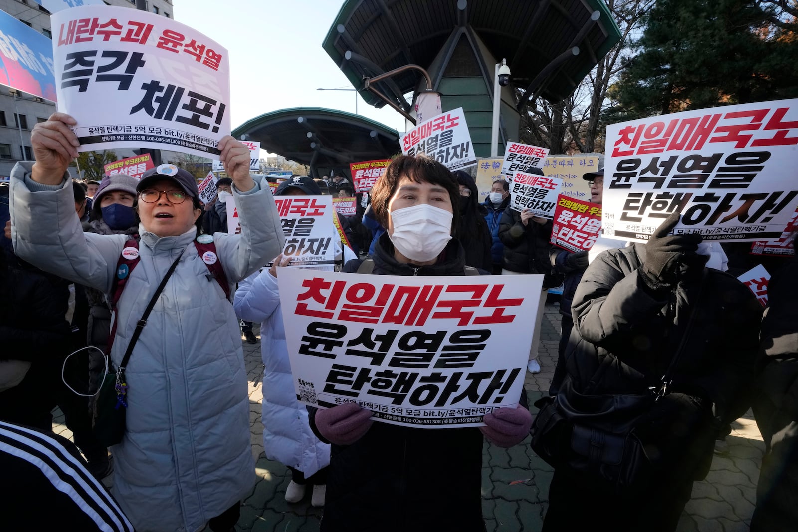 Members of main opposition Democratic Party stage a rally against South Korean President Yoon Suk Yeol in front of the National Assembly in Seoul, South Korea, Wednesday, Dec. 4, 2024. The signs read "Let's impeach Yoon Suk Yeol ." (AP Photo/Ahn Young-joon)